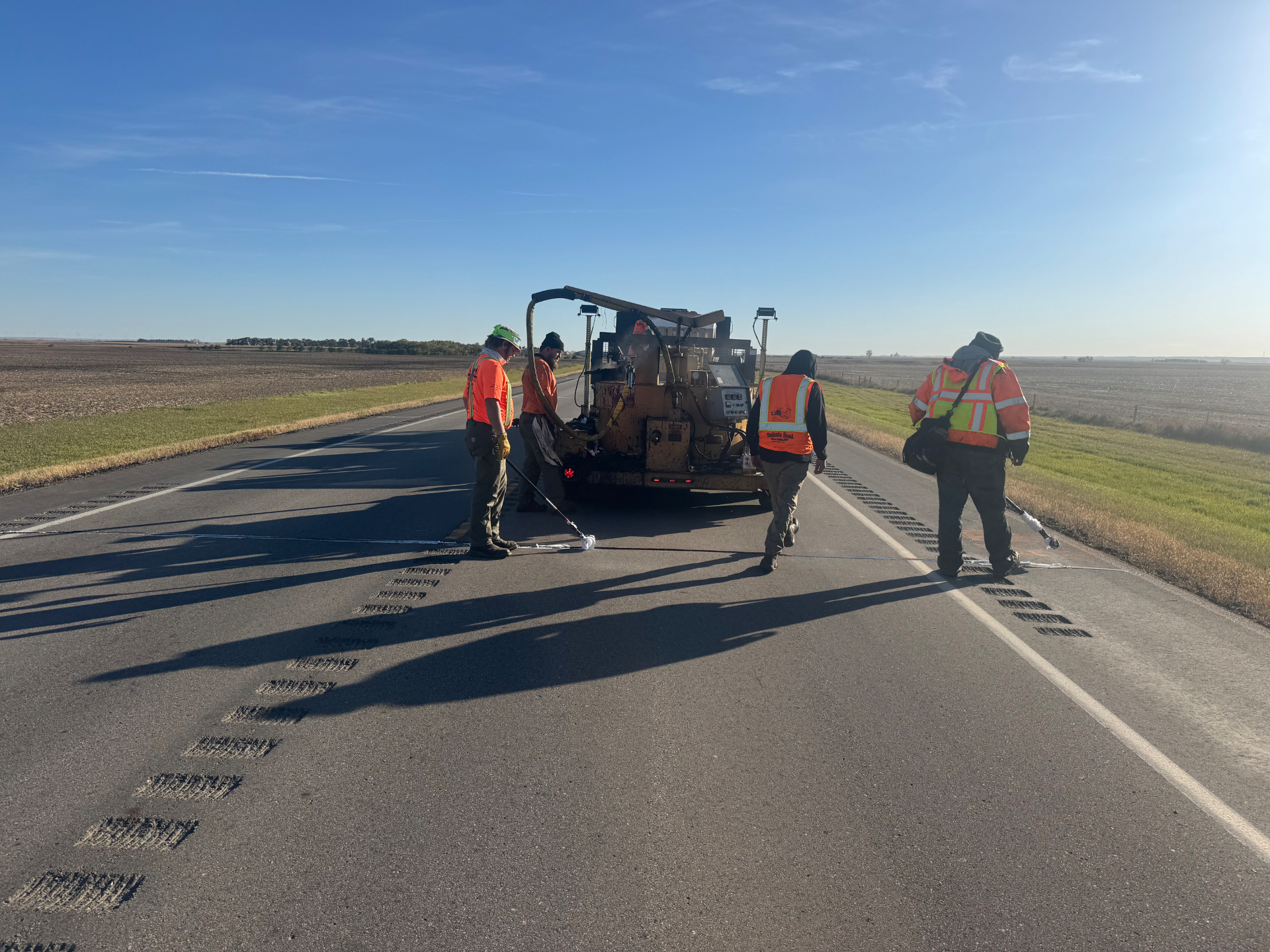 Dakota Seal crew applying seal coating on a Sioux Falls asphalt parking lot